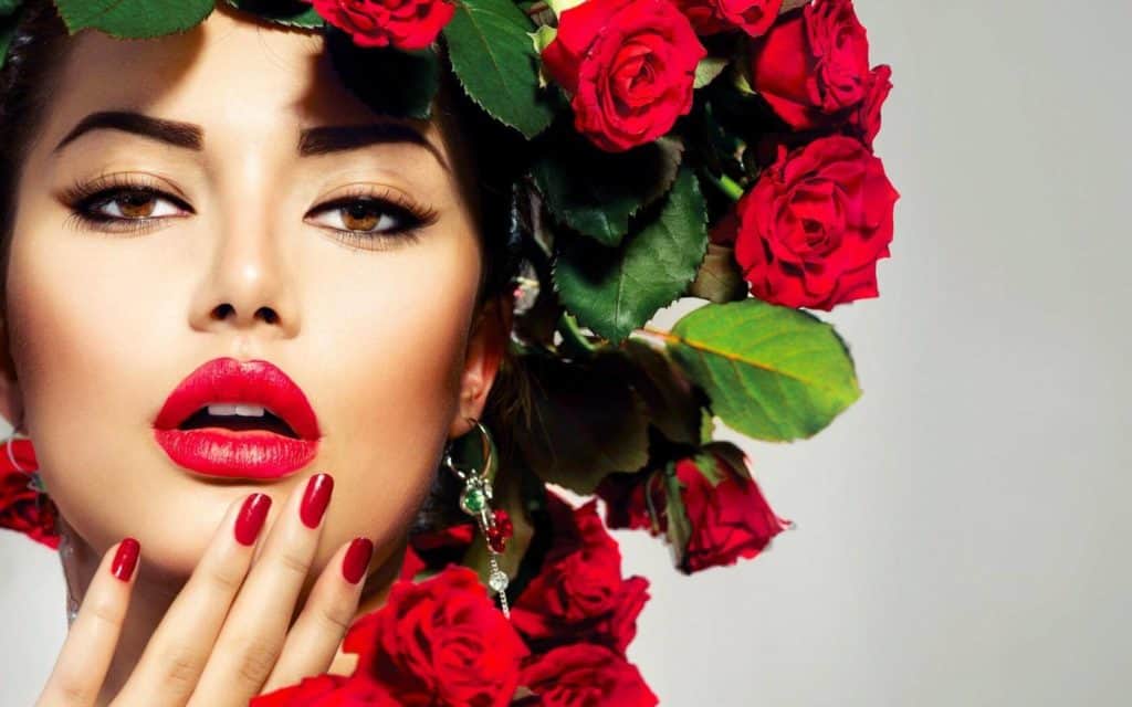 Model with roses in hair wearing natural lipstick