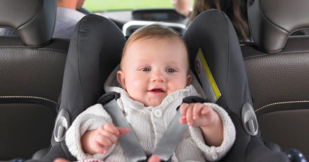 Smiling baby in car seat